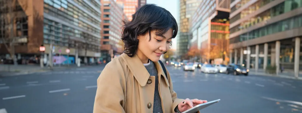 portrait young korean student girl walks city with digital tablet stands street uses her